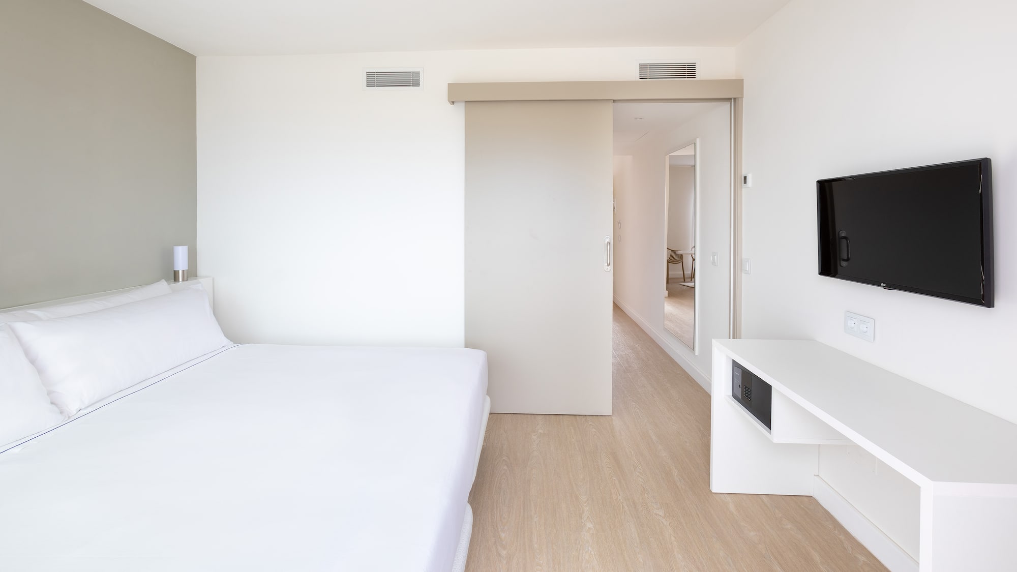 a bedroom with a bed and a tv