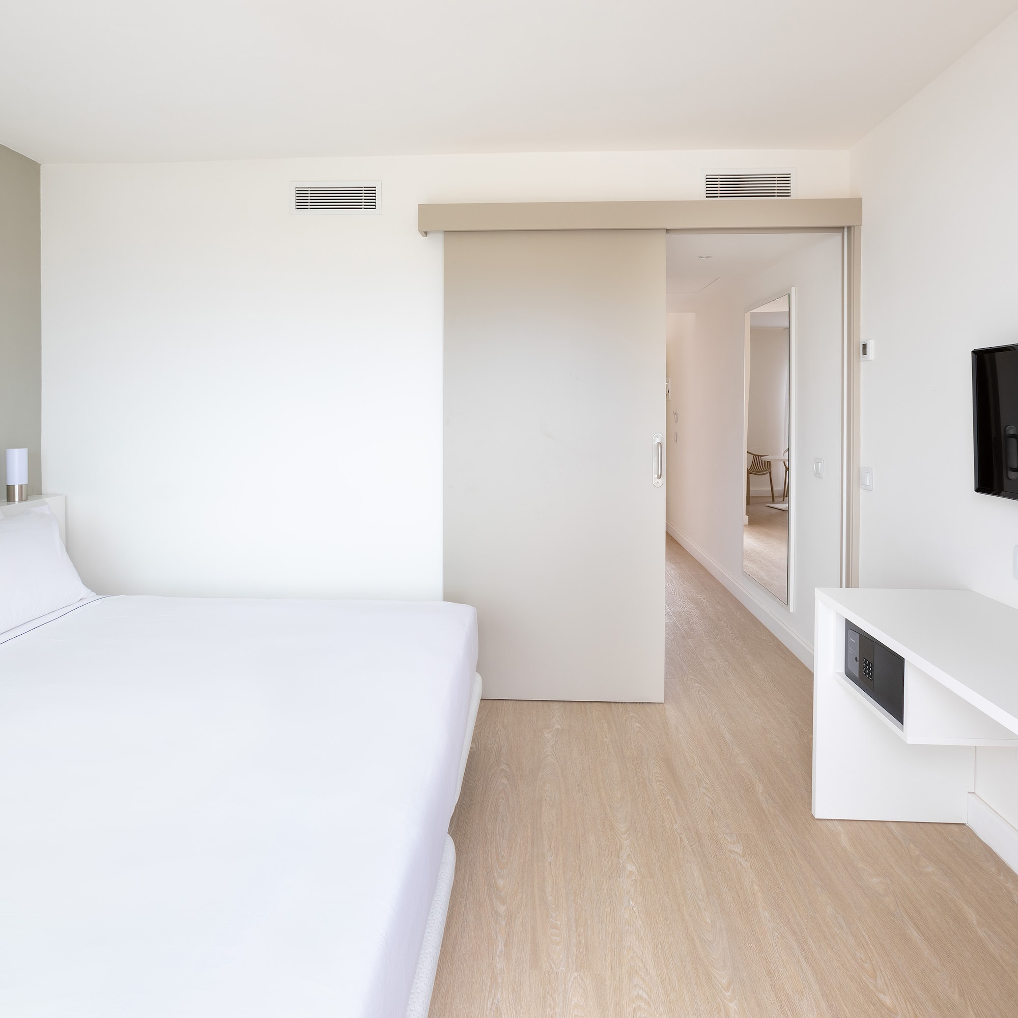 a bedroom with a bed and a tv