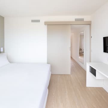 a bedroom with a bed and a tv