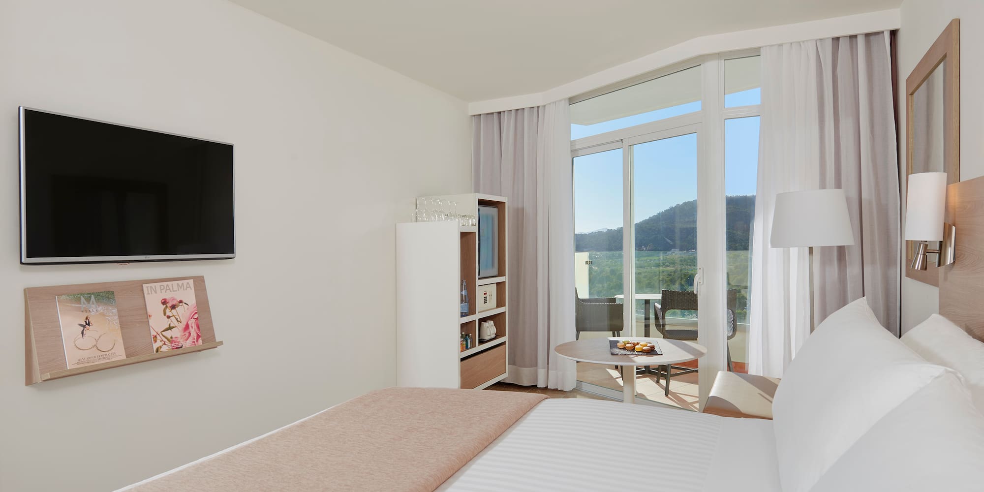 a bedroom with a television and a bed