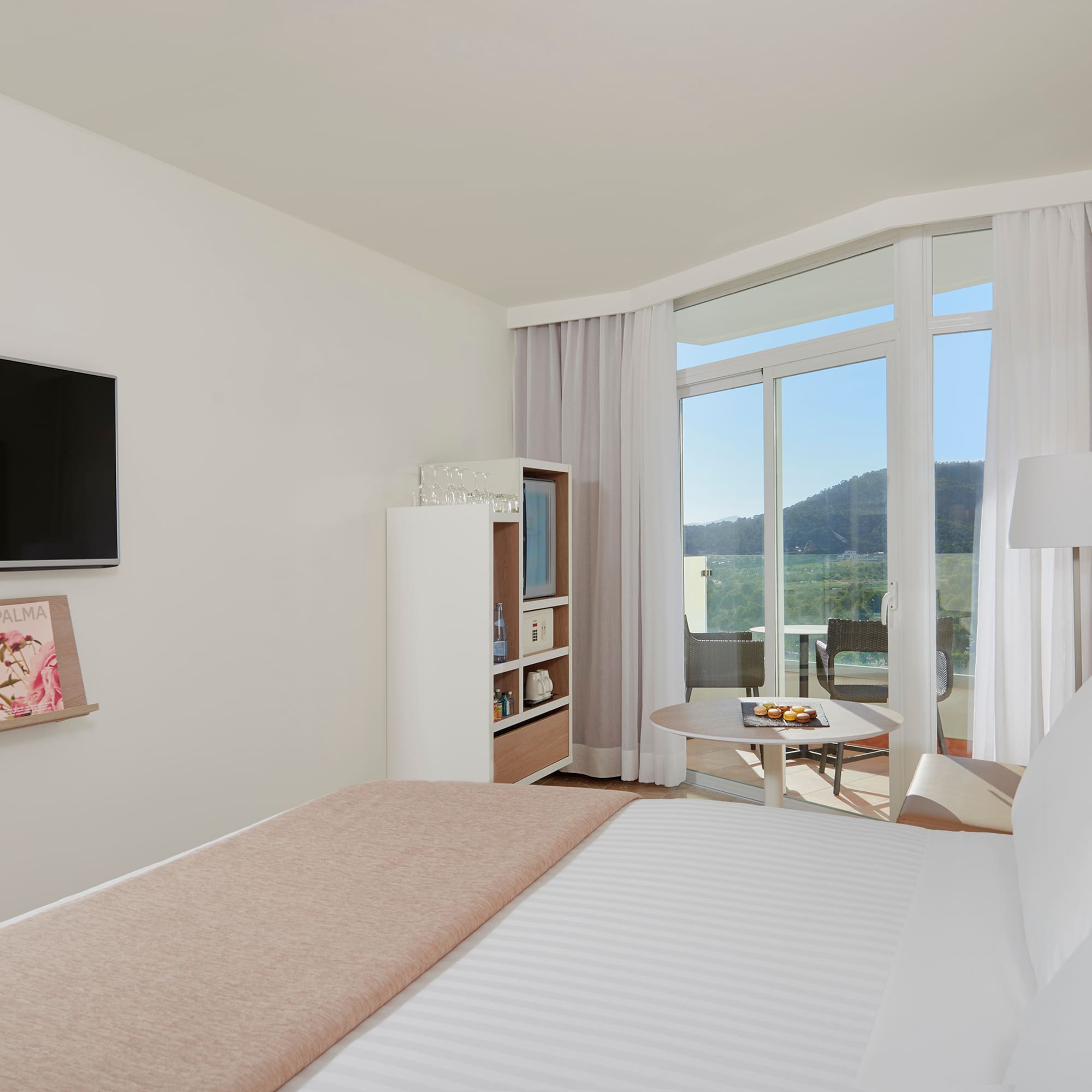 a bedroom with a television and a bed