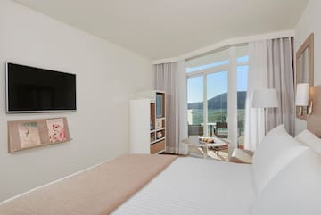 a bedroom with a television and a bed