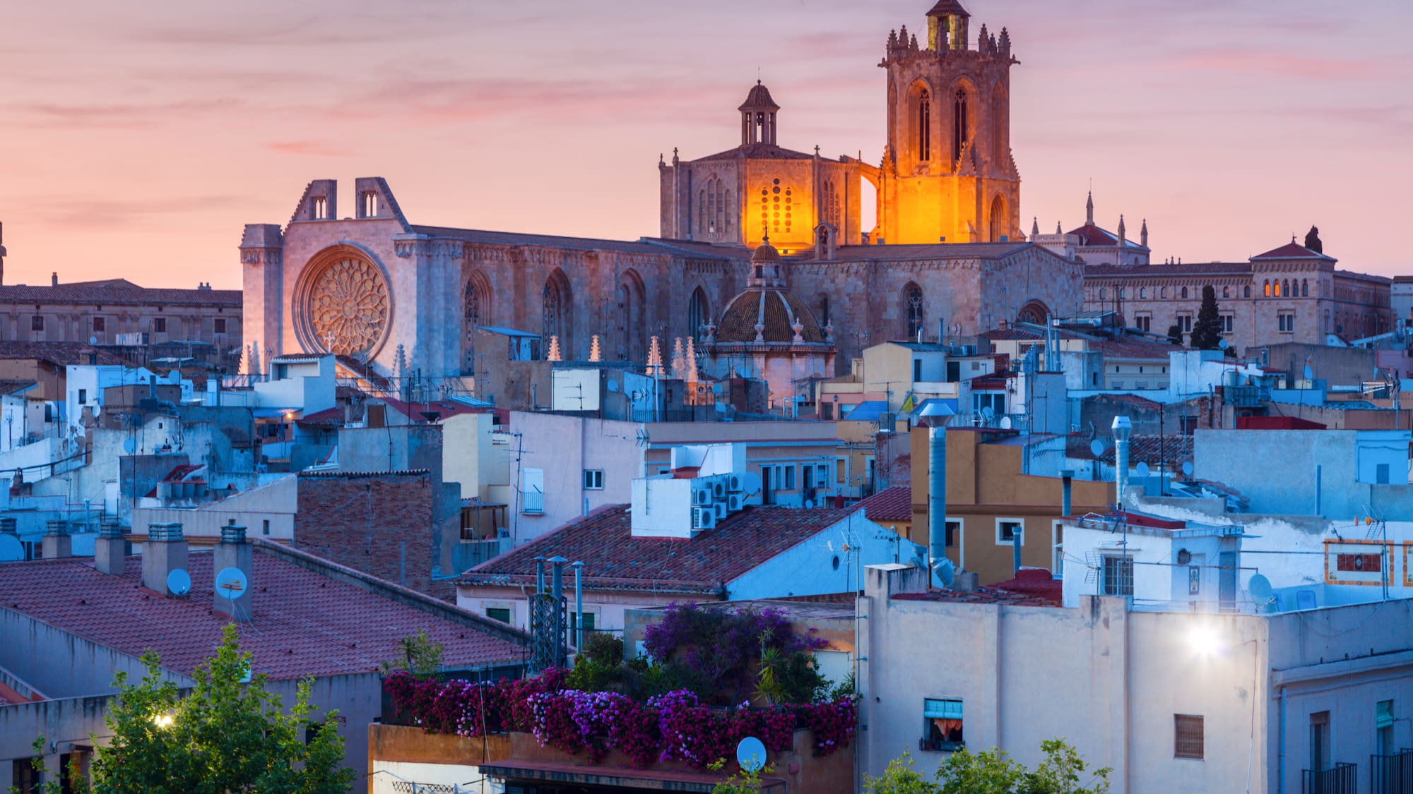 a large building with a tower in the middle of a city