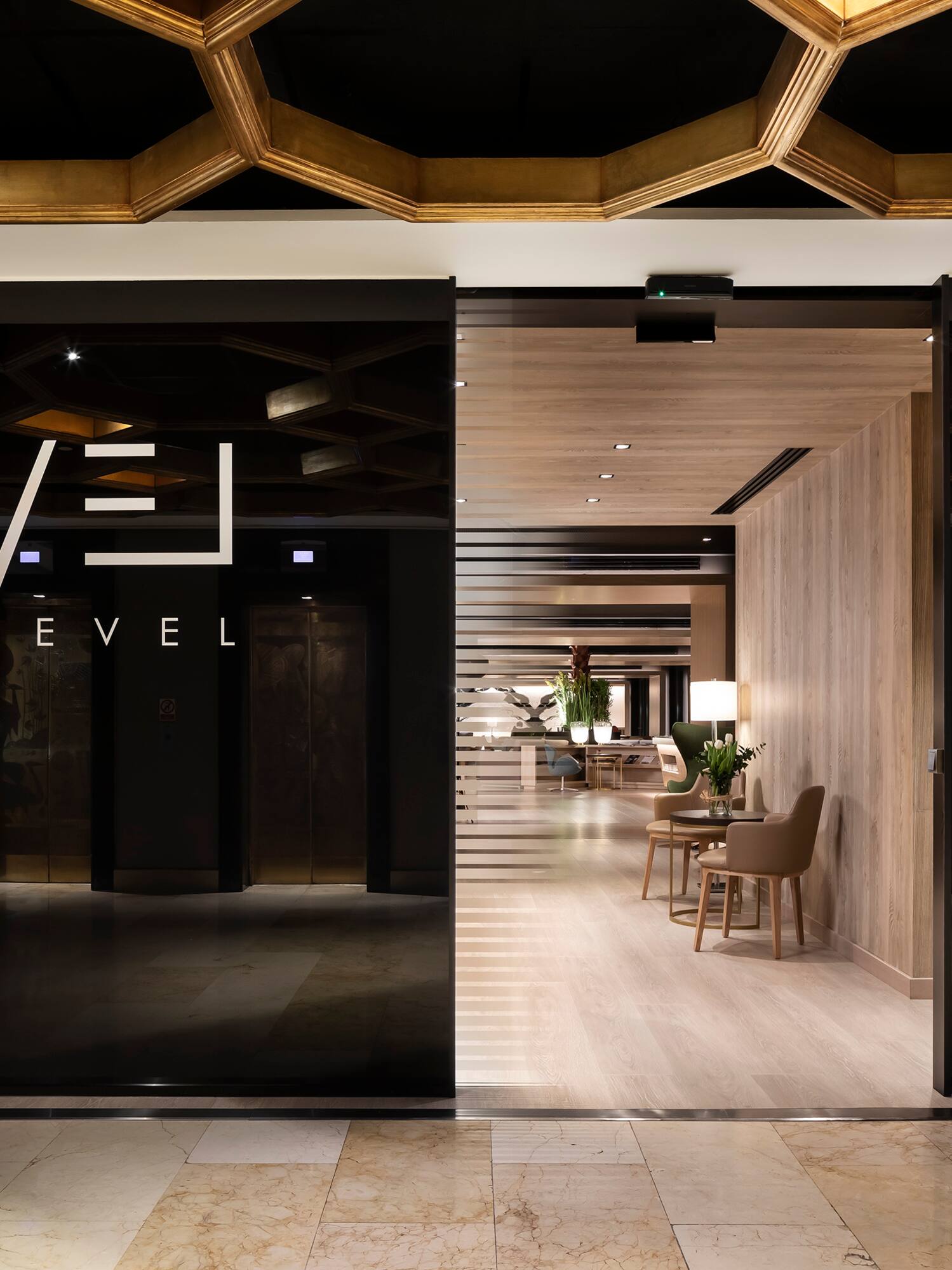 a glass door with a black sign