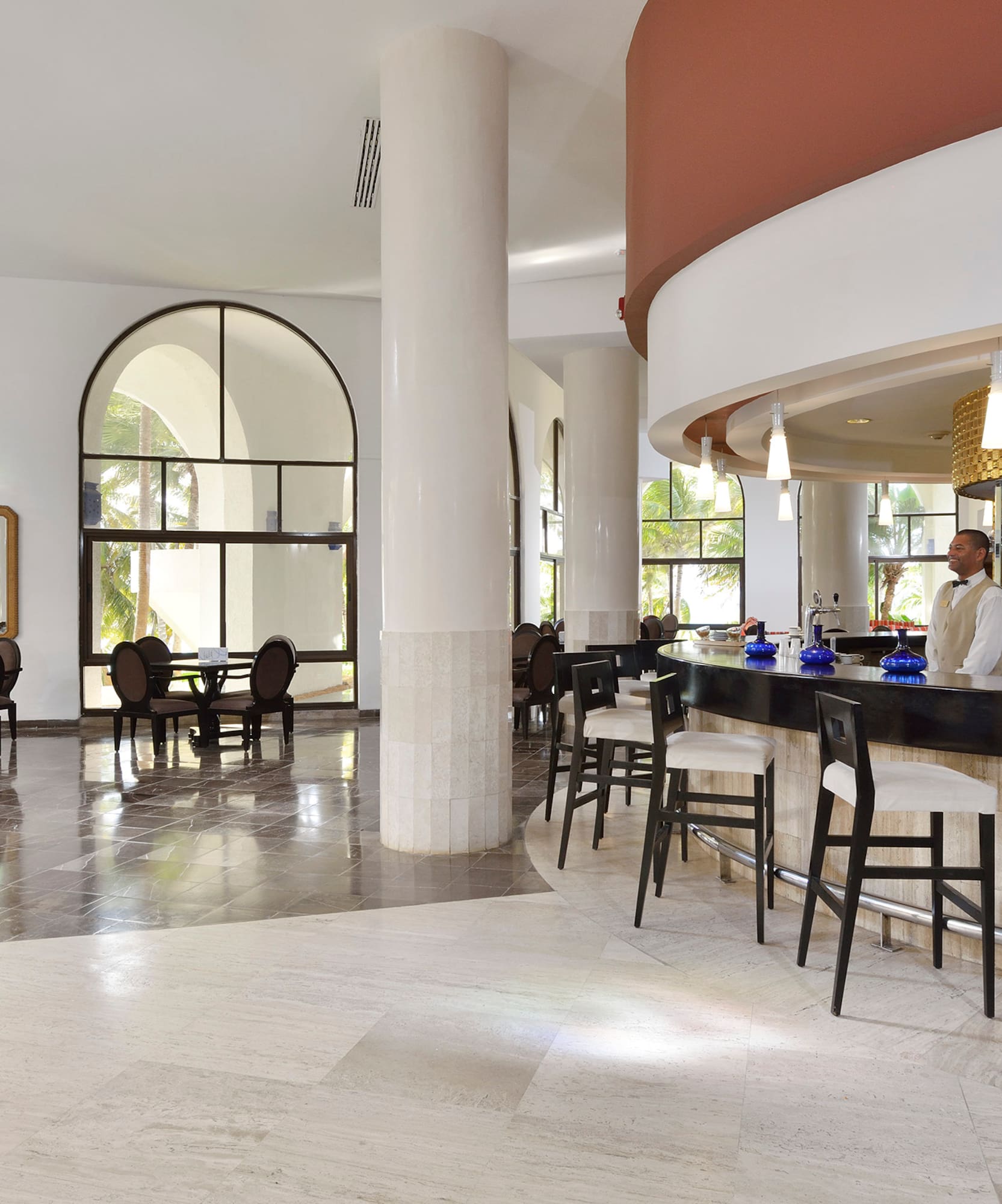 a bar with chairs and tables in a room