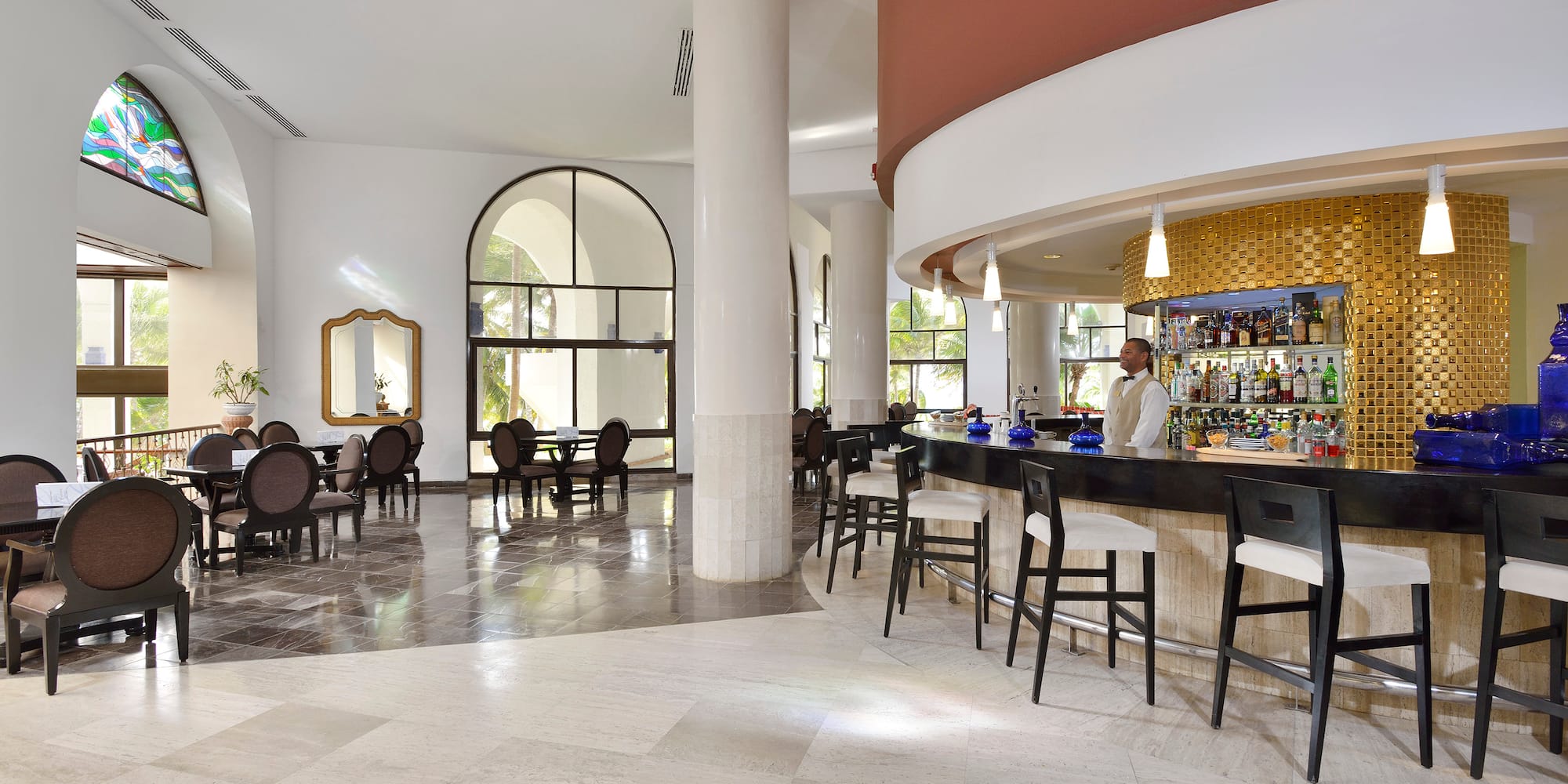 a bar with chairs and tables in a room
