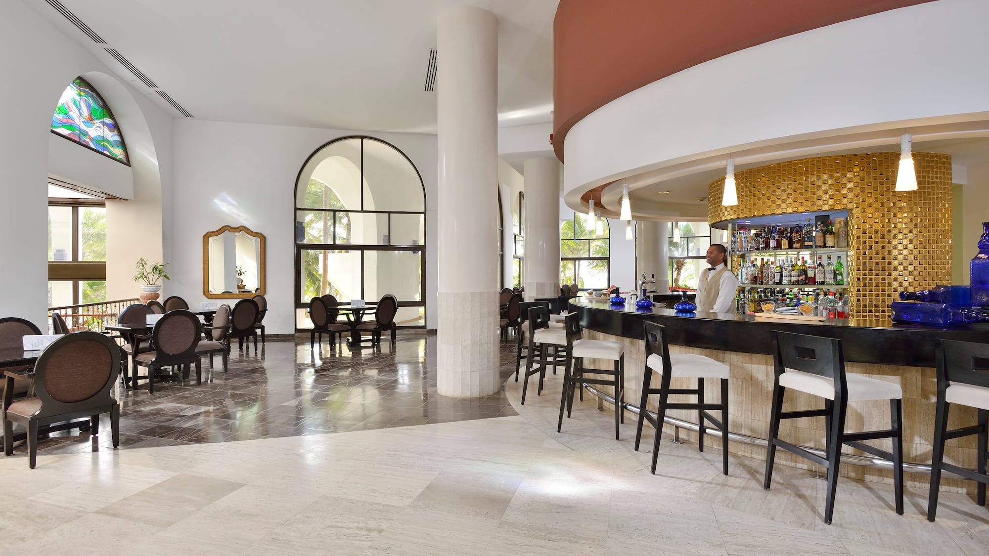 a bar with chairs and tables in a room
