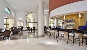 a bar with chairs and tables in a room