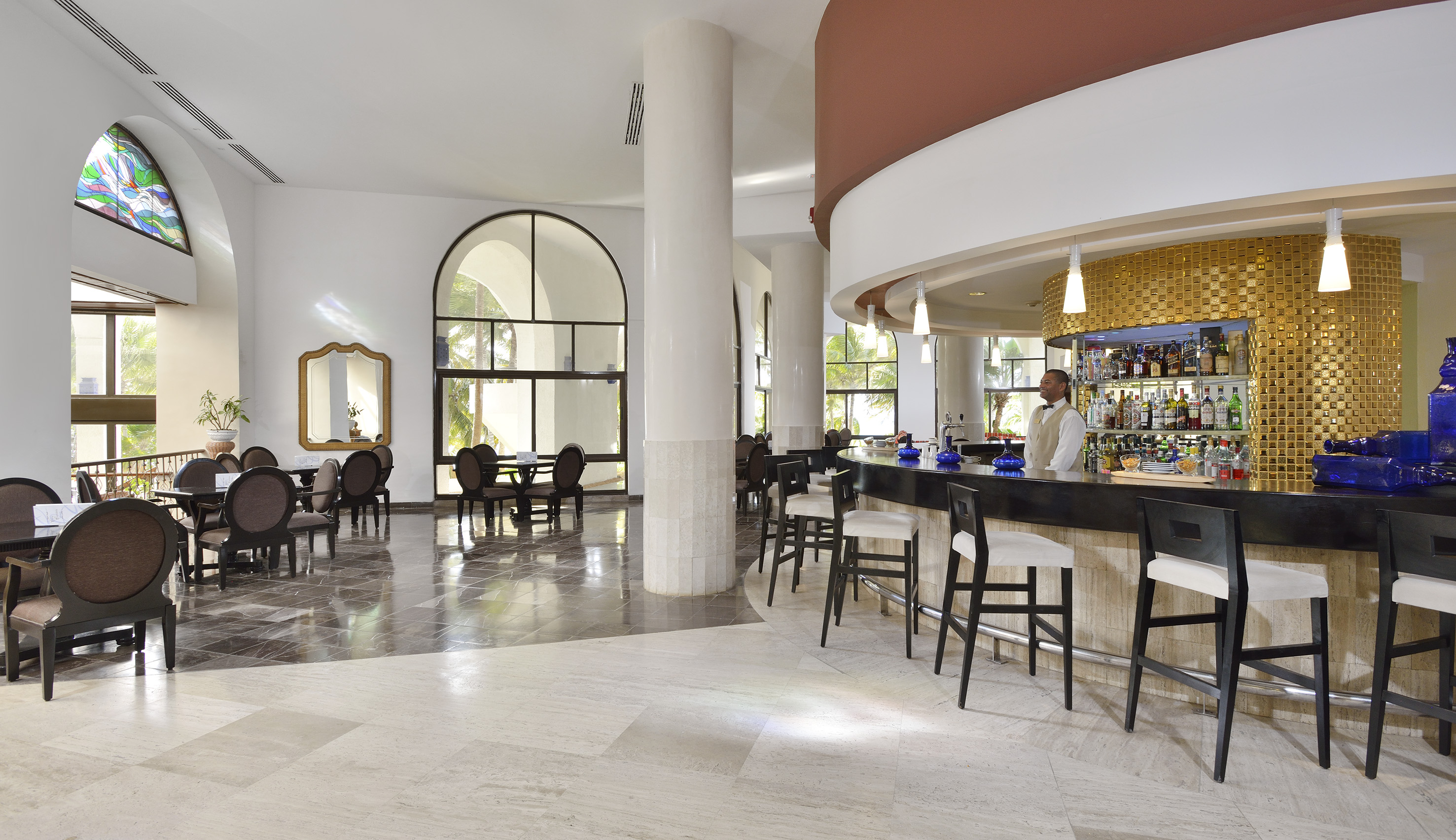 a bar with chairs and tables in a room