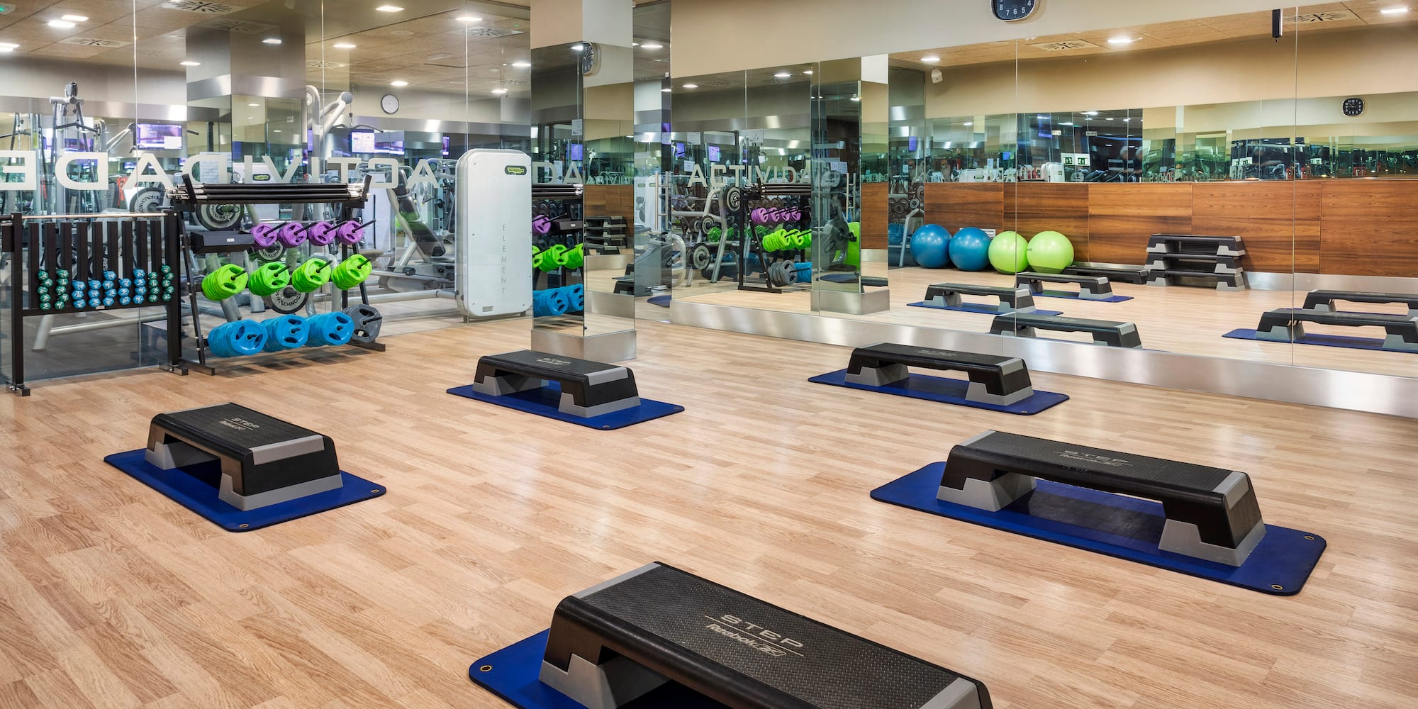a room with exercise equipment and a mirror