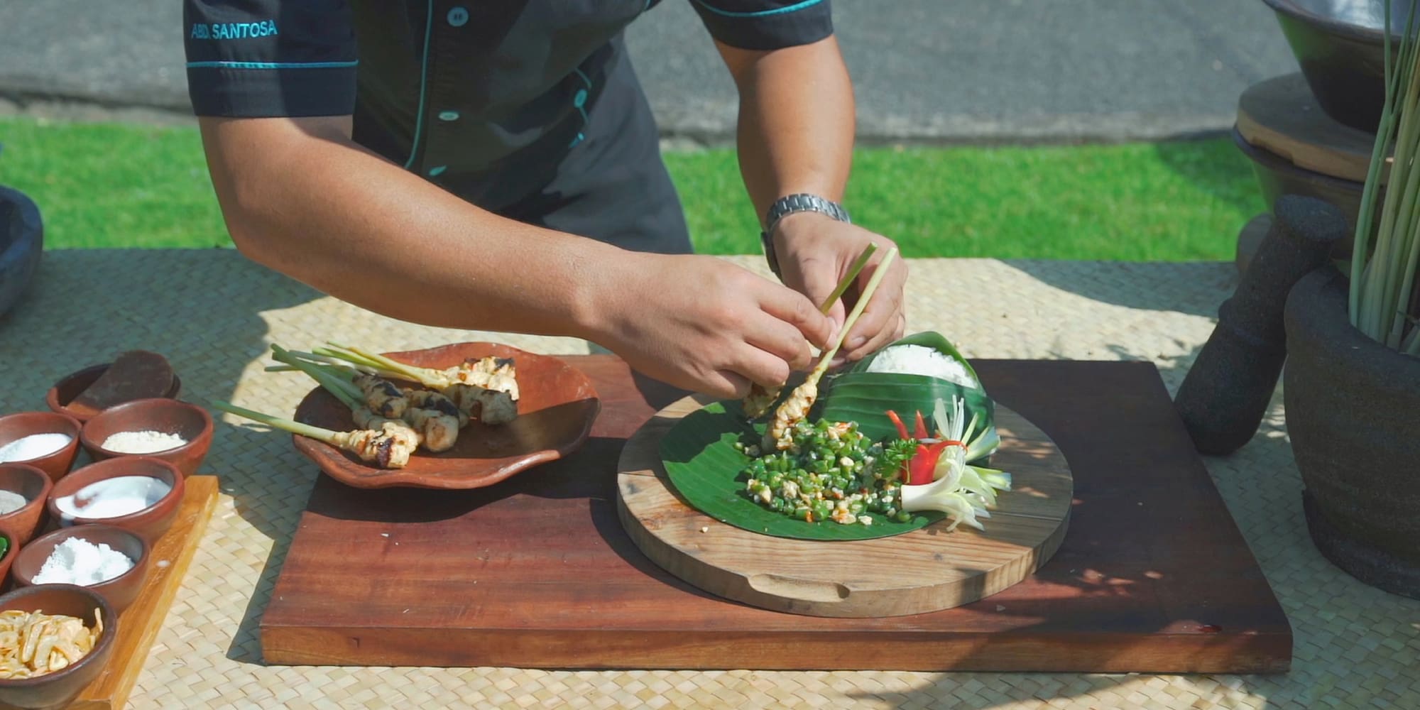 a person holding chopsticks over a plate of food