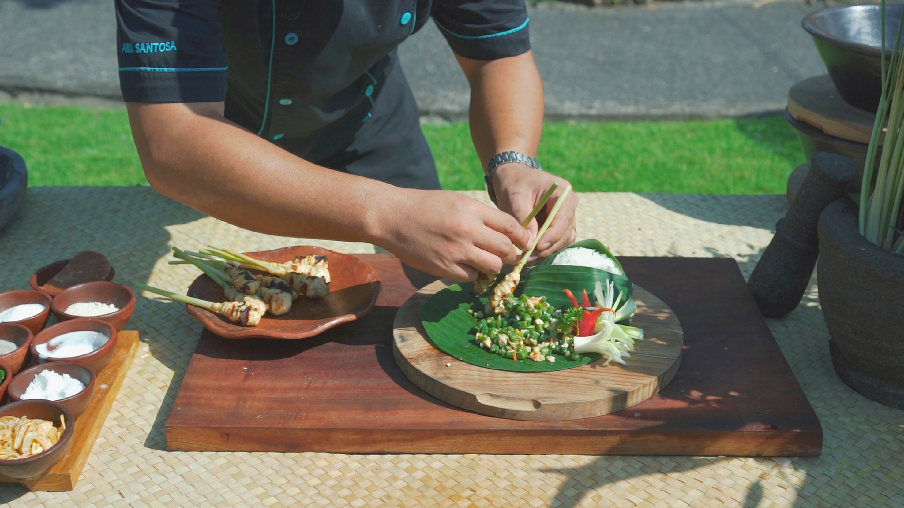 a person holding chopsticks over a plate of food
