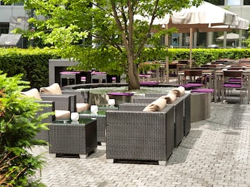 a patio area with tables and chairs
