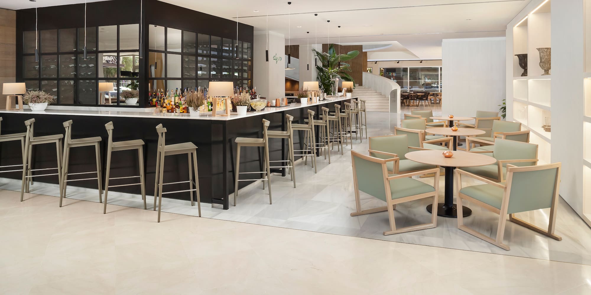 a room with a bar and chairs