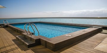 a pool with a deck and railing