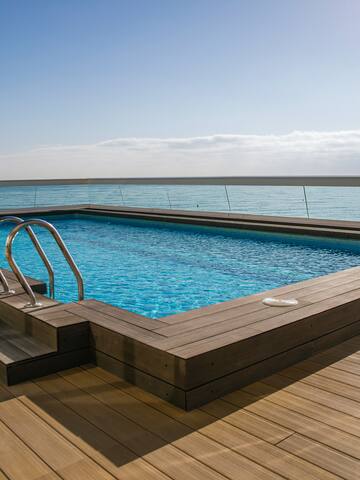 a pool with a deck and railing