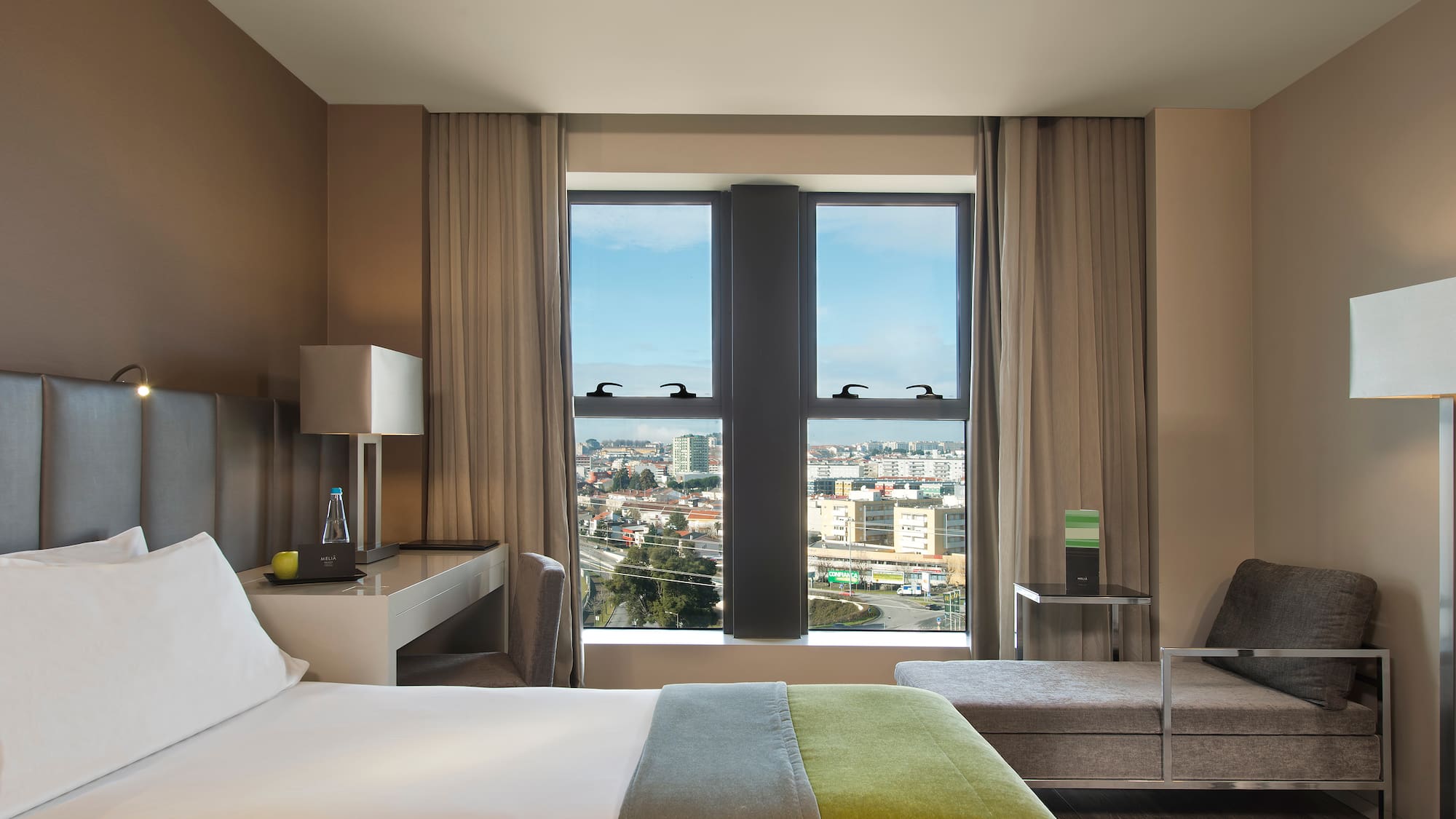 a room with a bed and a table and chairs