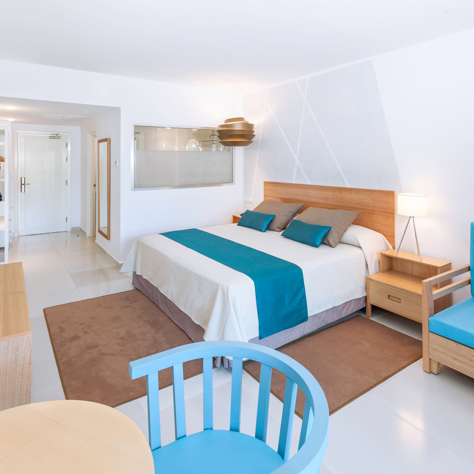 a bedroom with a bed and chairs