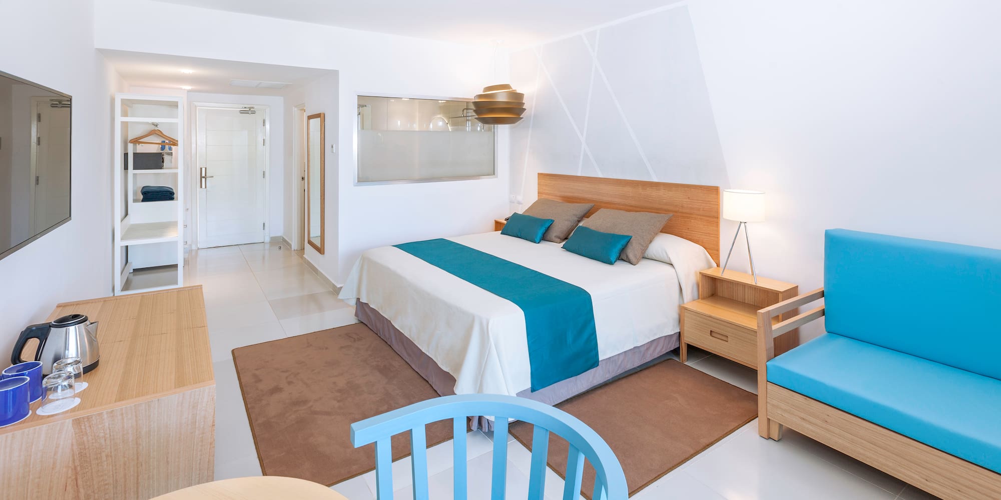 a bedroom with a bed and chairs