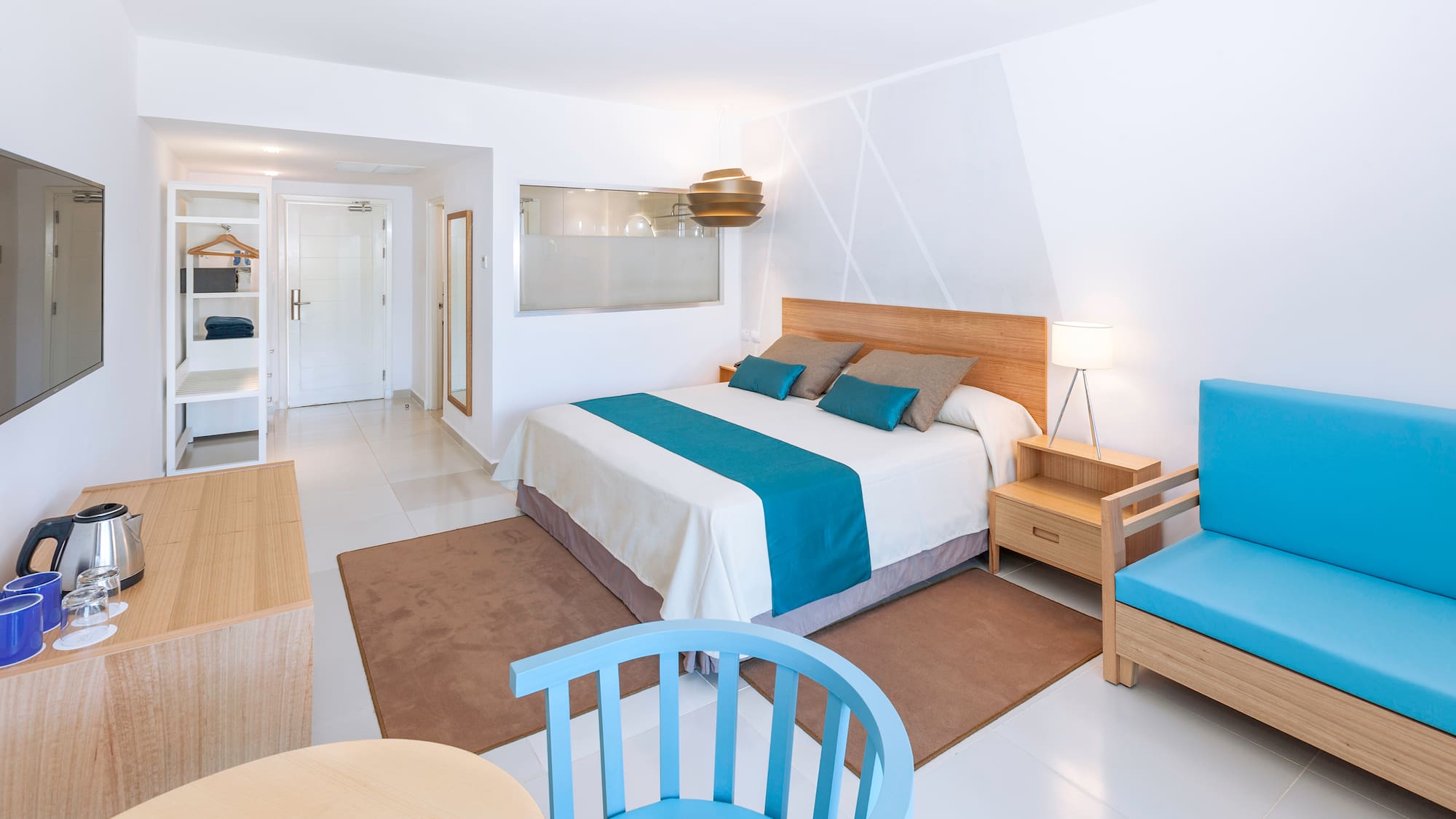 a bedroom with a bed and chairs