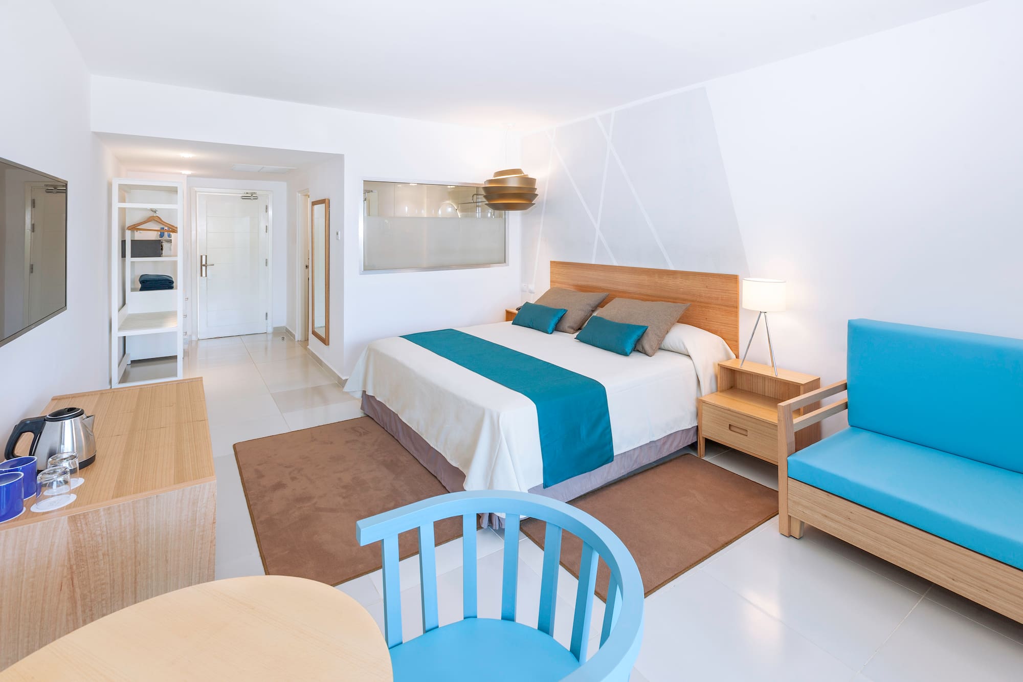 a bedroom with a bed and chairs