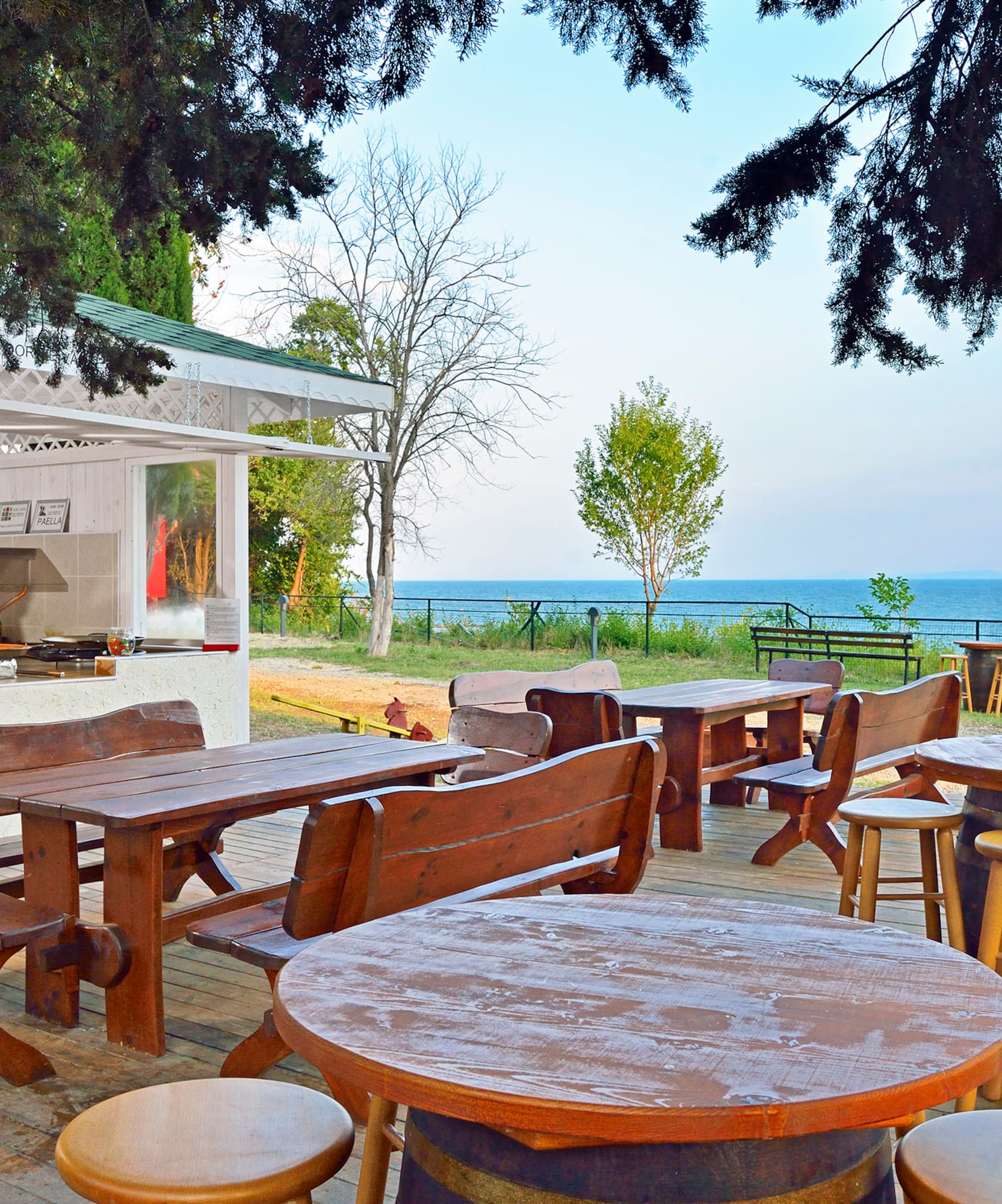 a table and chairs outside with a view of the ocean