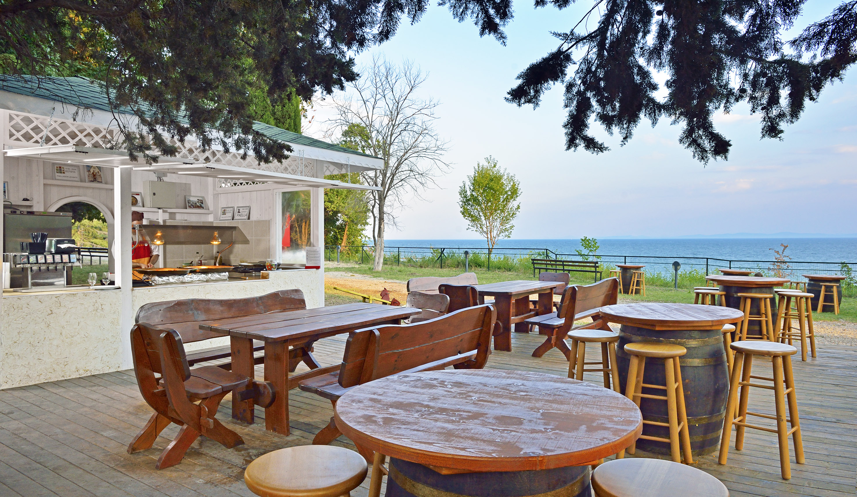 a table and chairs outside with a view of the ocean