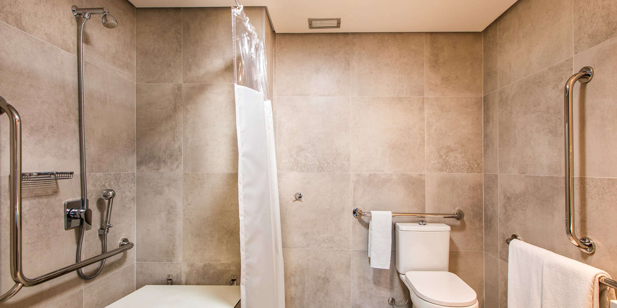 a bathroom with a shower curtain and a toilet