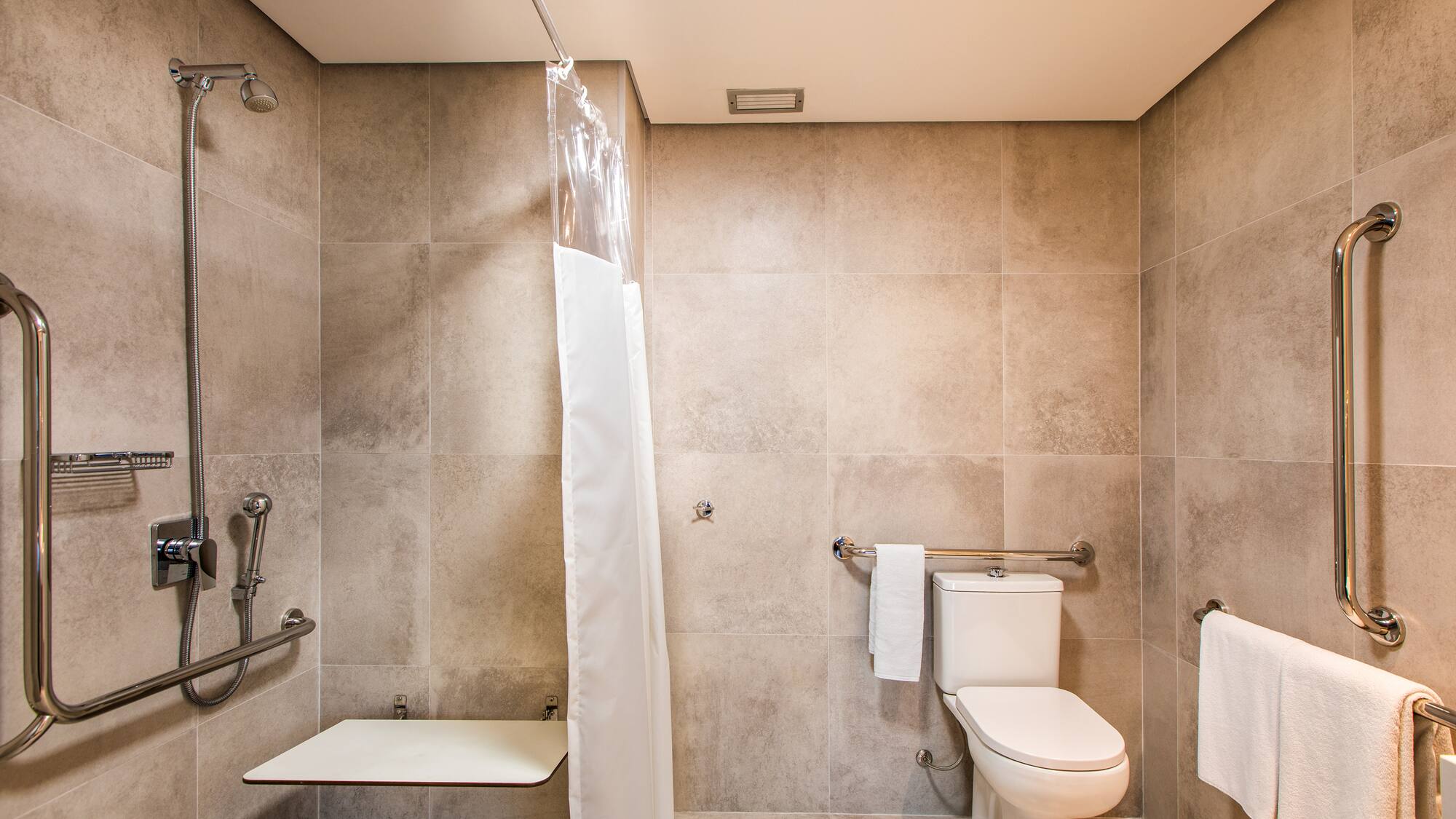 a bathroom with a shower curtain and a toilet