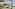 Luxury daybed overlooking Palma marina with cathedral, sailboats, and pool.