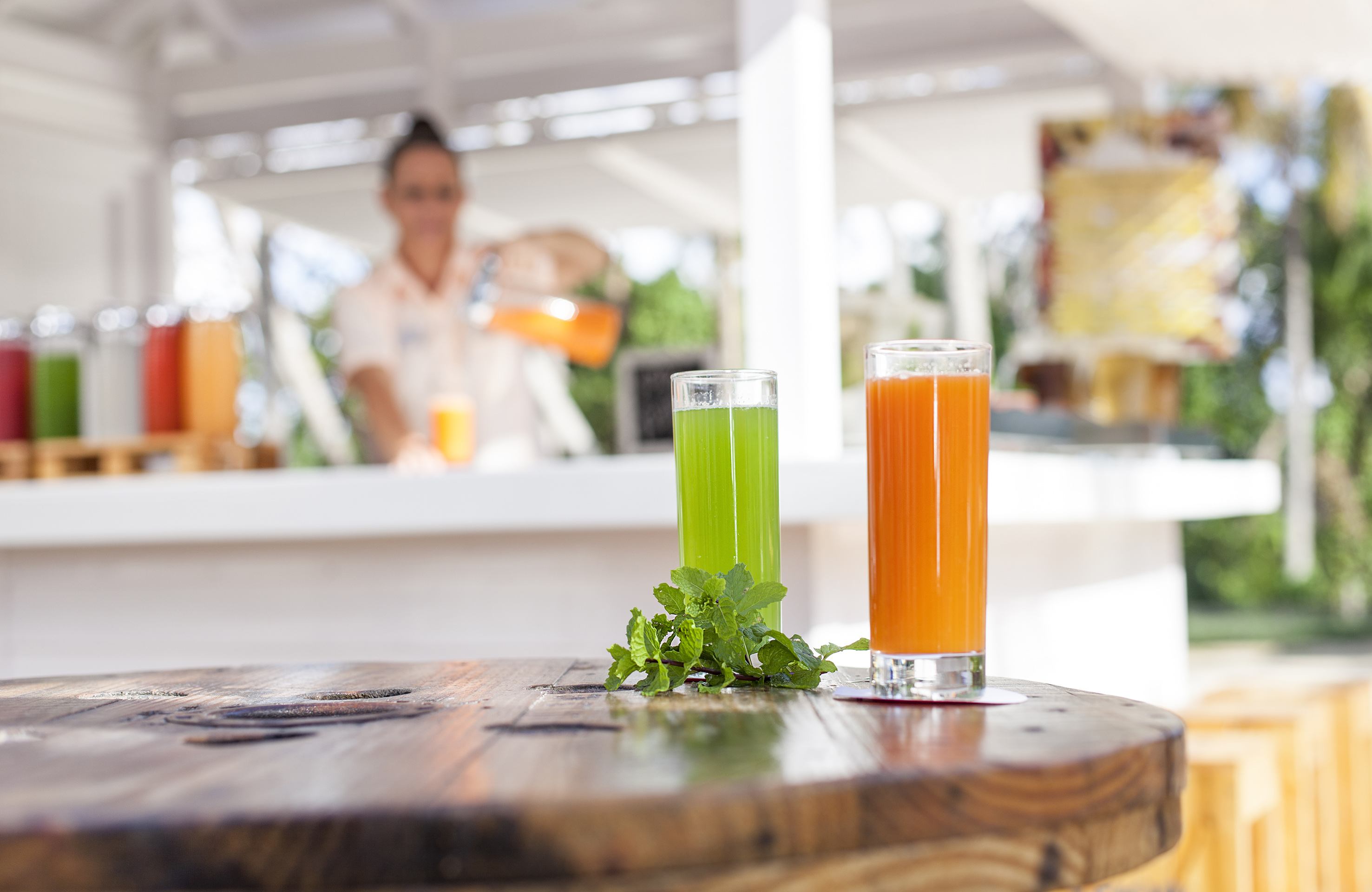 a couple of glasses of juice on a table