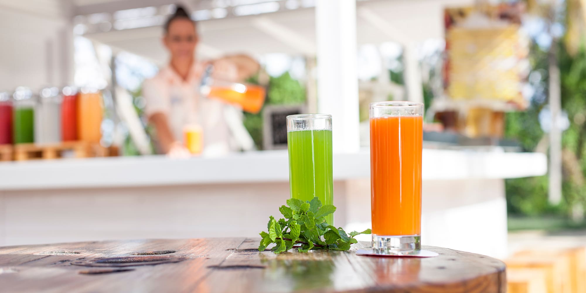 a couple of glasses of juice on a table