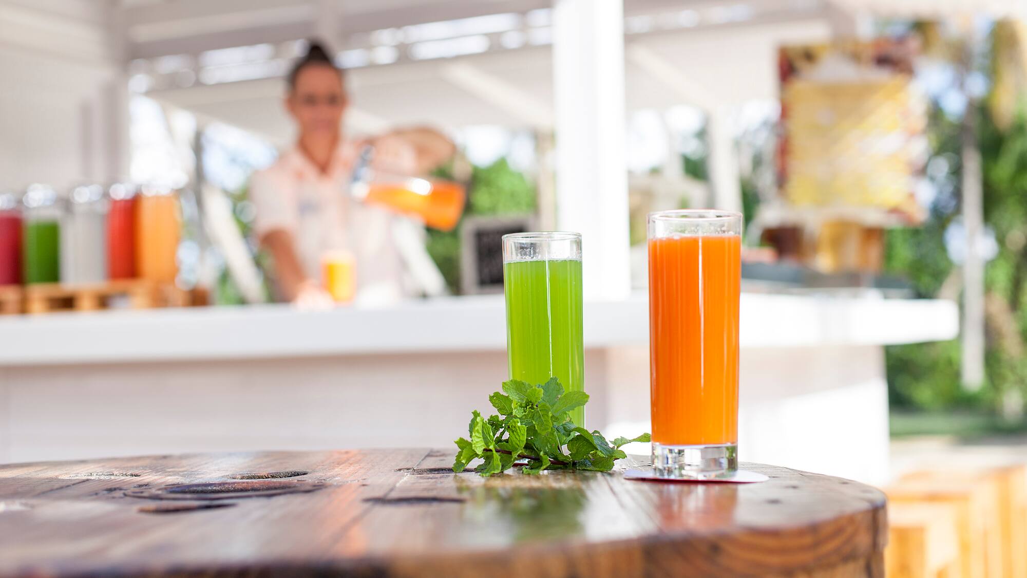 a couple of glasses of juice on a table