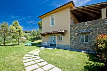 a house with a stone walkway and lawn