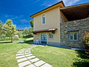 a house with a stone walkway and lawn