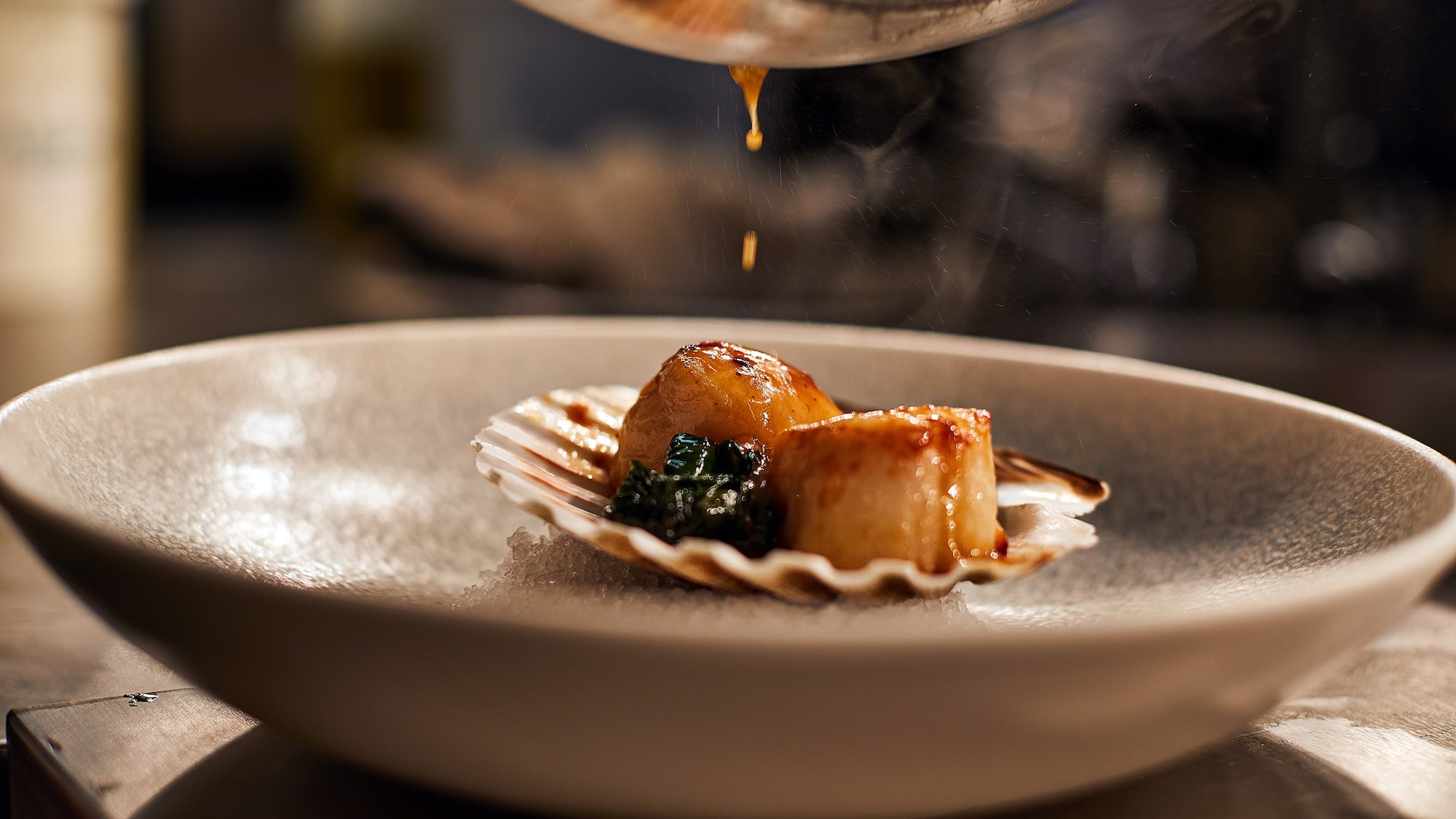 a plate of food with sauce being poured over