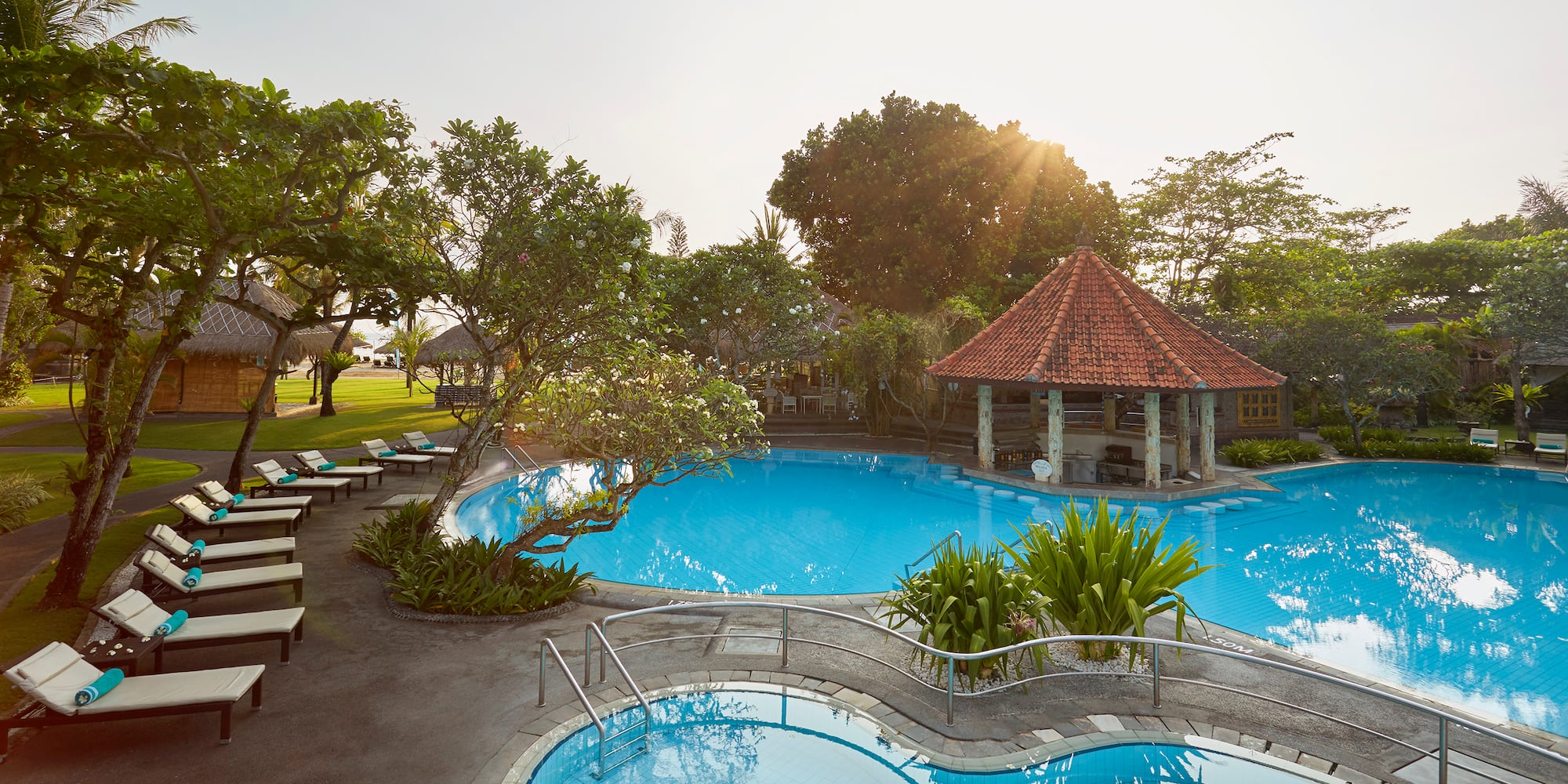 a pool with a gazebo and trees