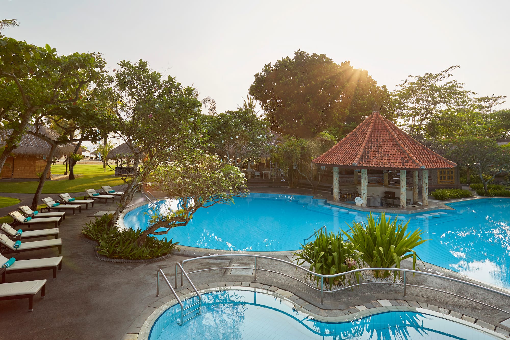 a pool with a gazebo and trees