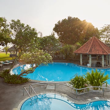 a pool with a gazebo and trees