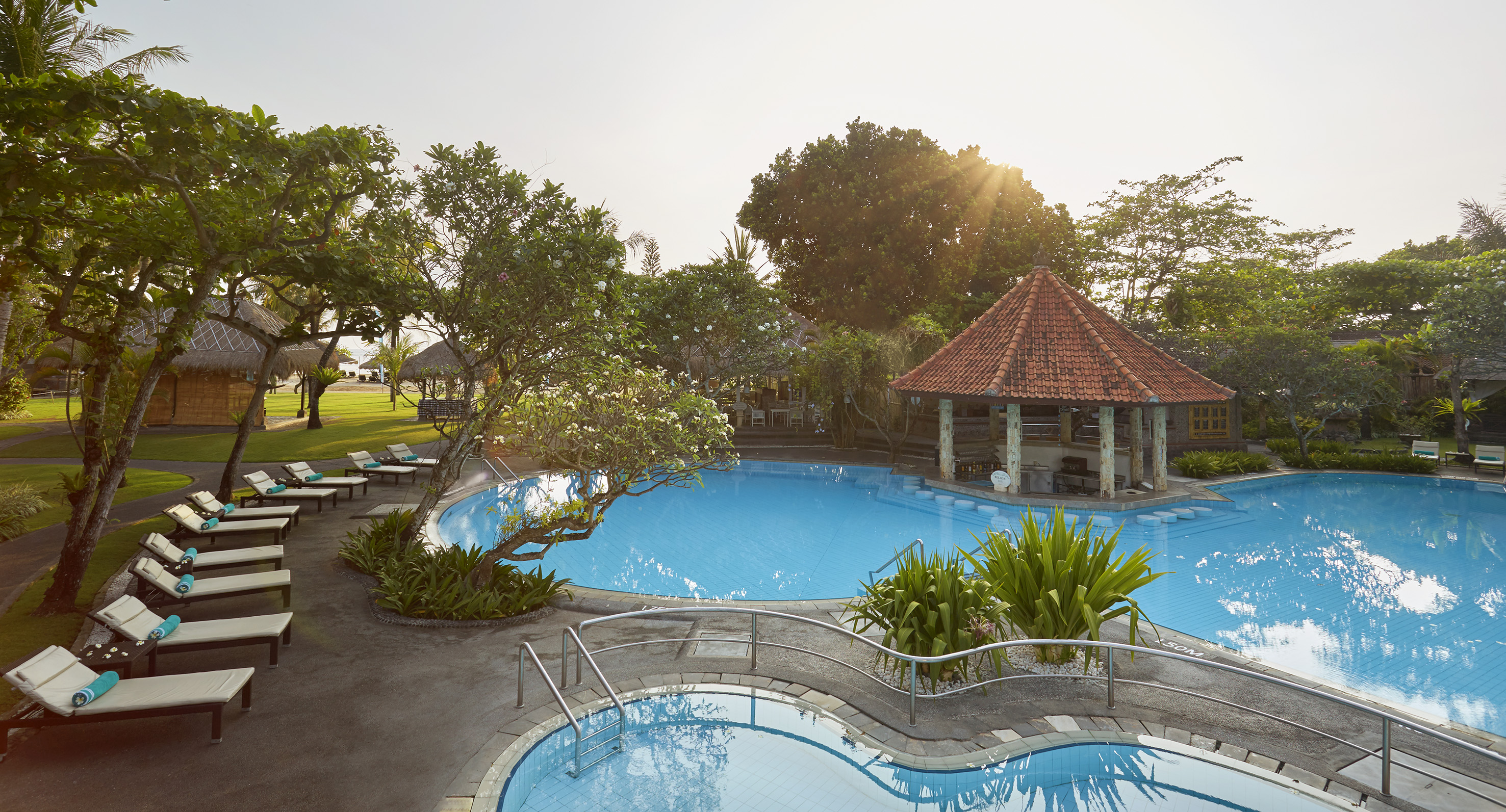 a pool with a gazebo and trees