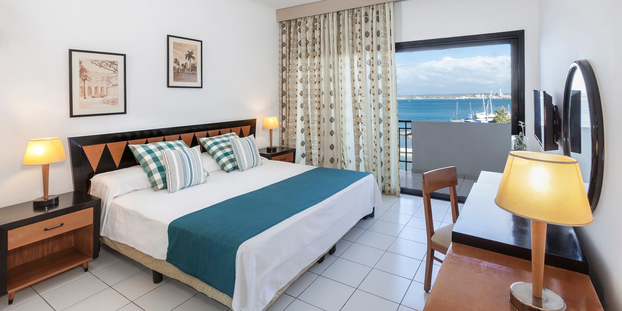 a bedroom with a bed and a table and chairs