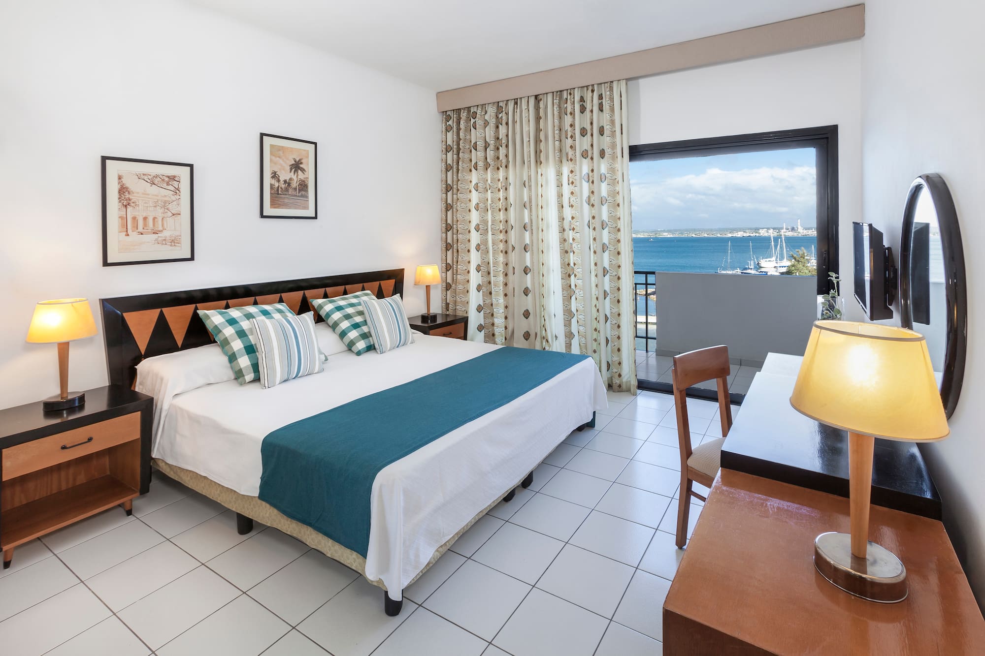 a bedroom with a bed and a table and chairs