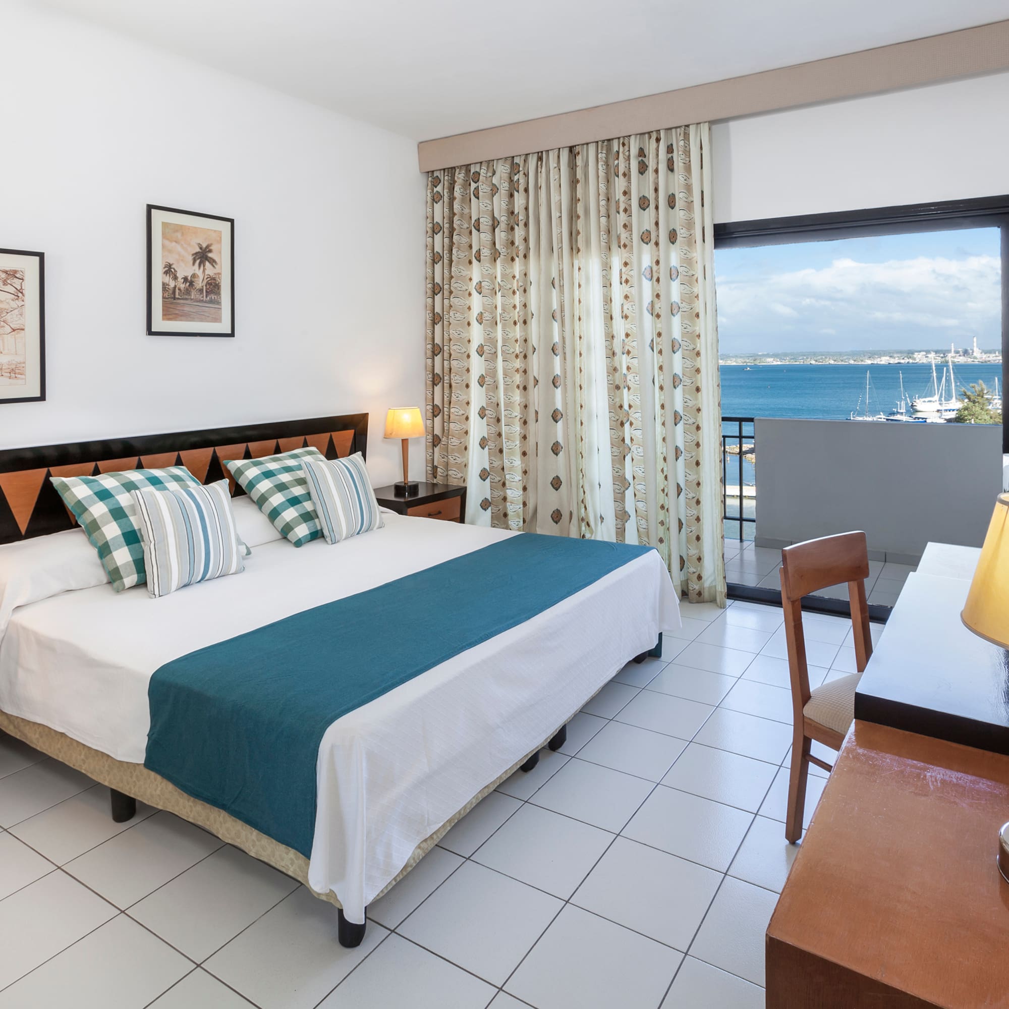 a bedroom with a bed and a table and chairs