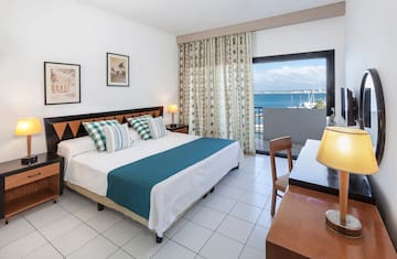 a bedroom with a bed and a table and chairs