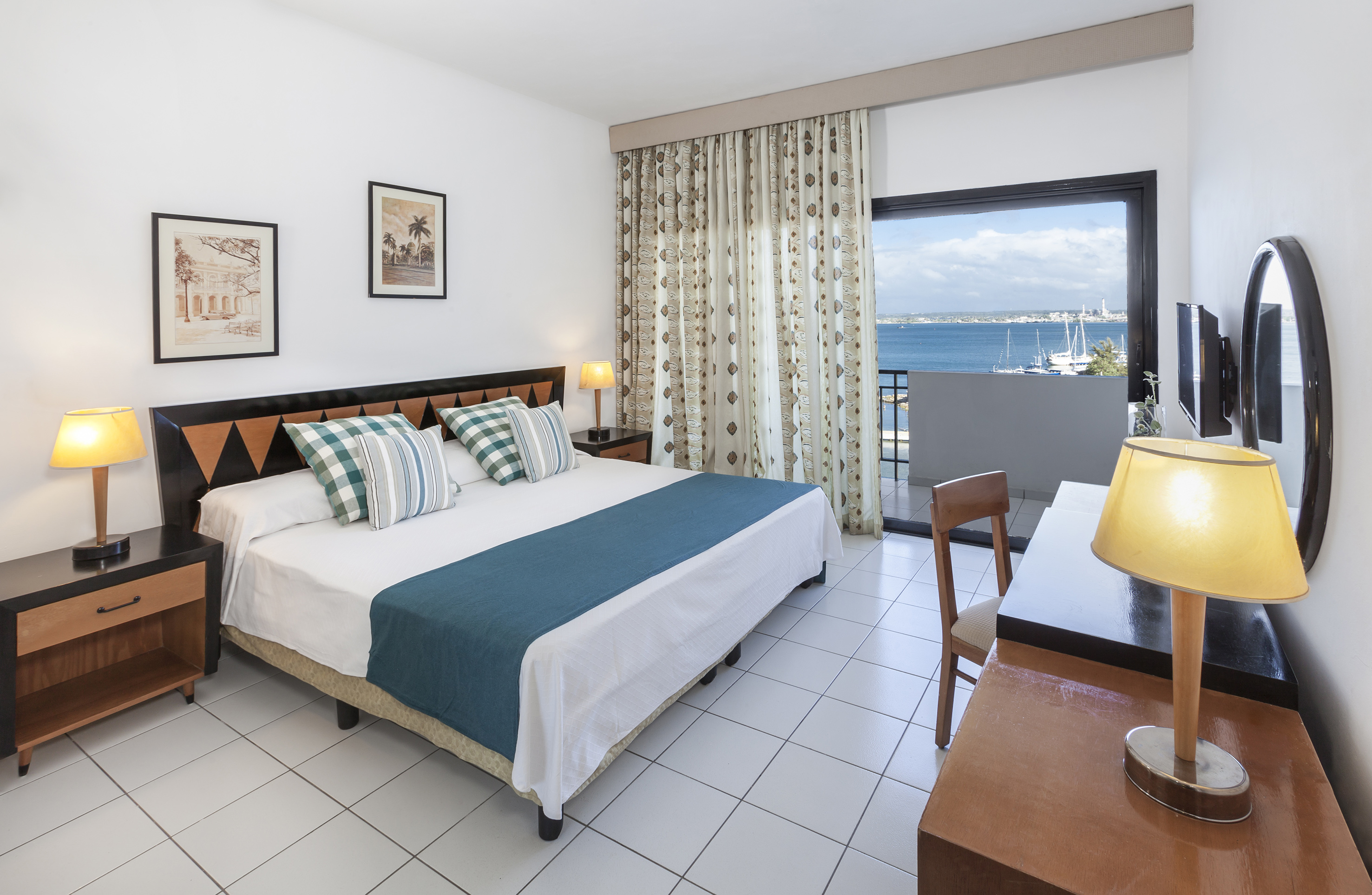 a bedroom with a bed and a table and chairs