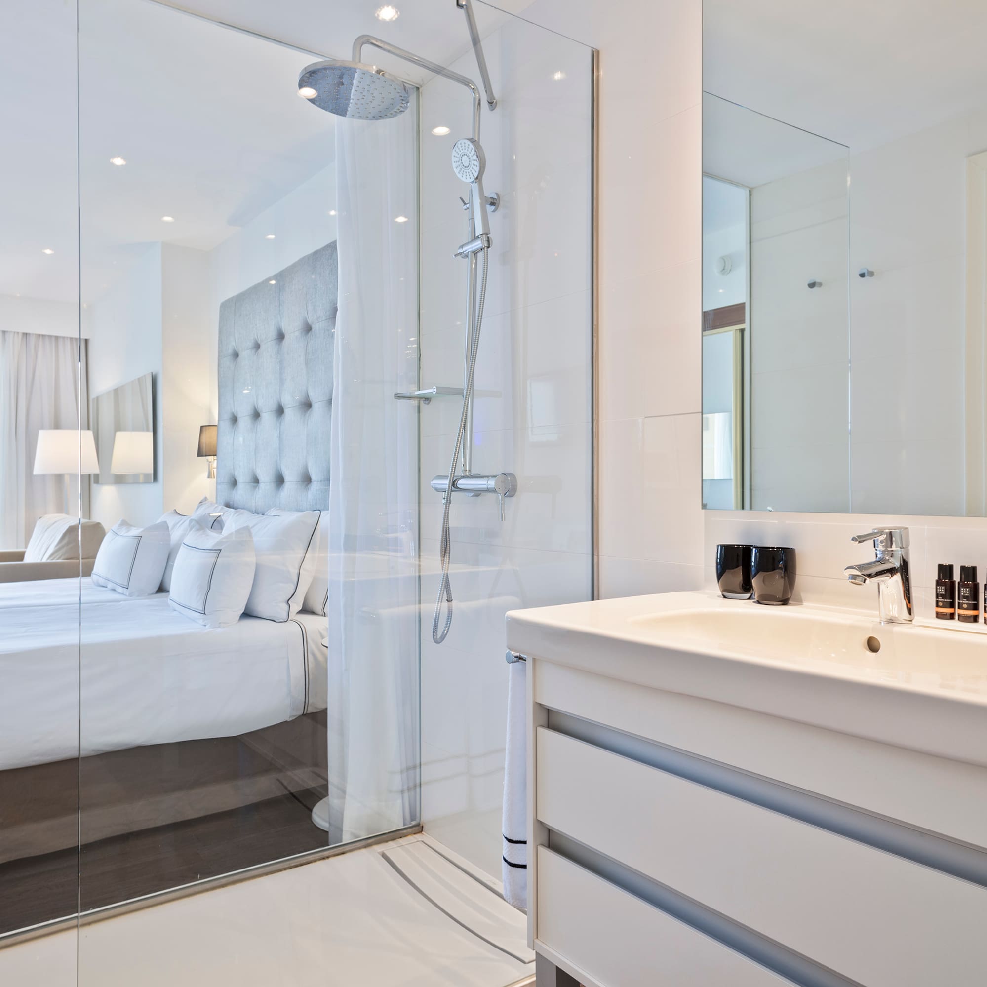 a bathroom with a shower and a bed