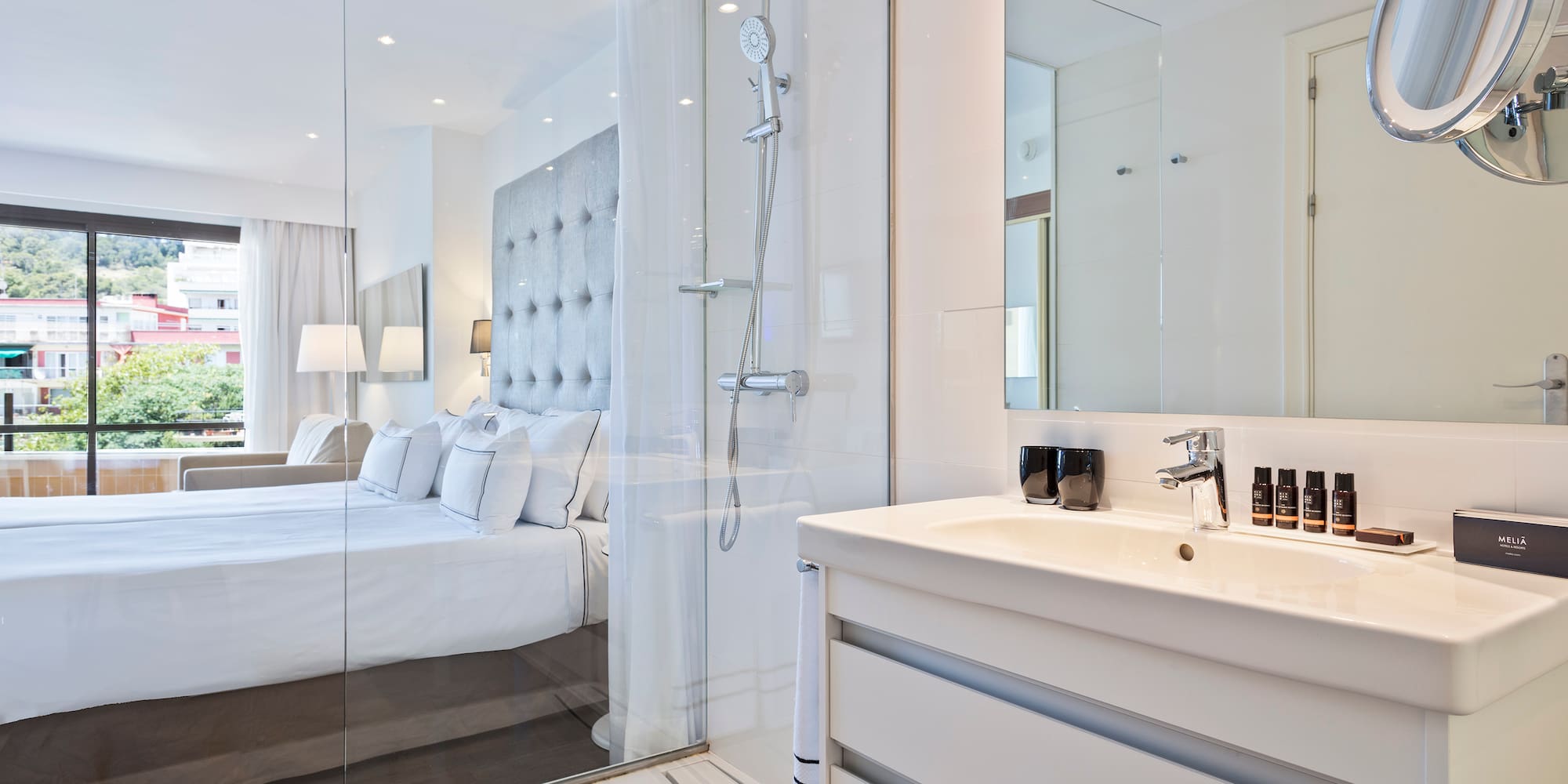 a bathroom with a shower and a bed