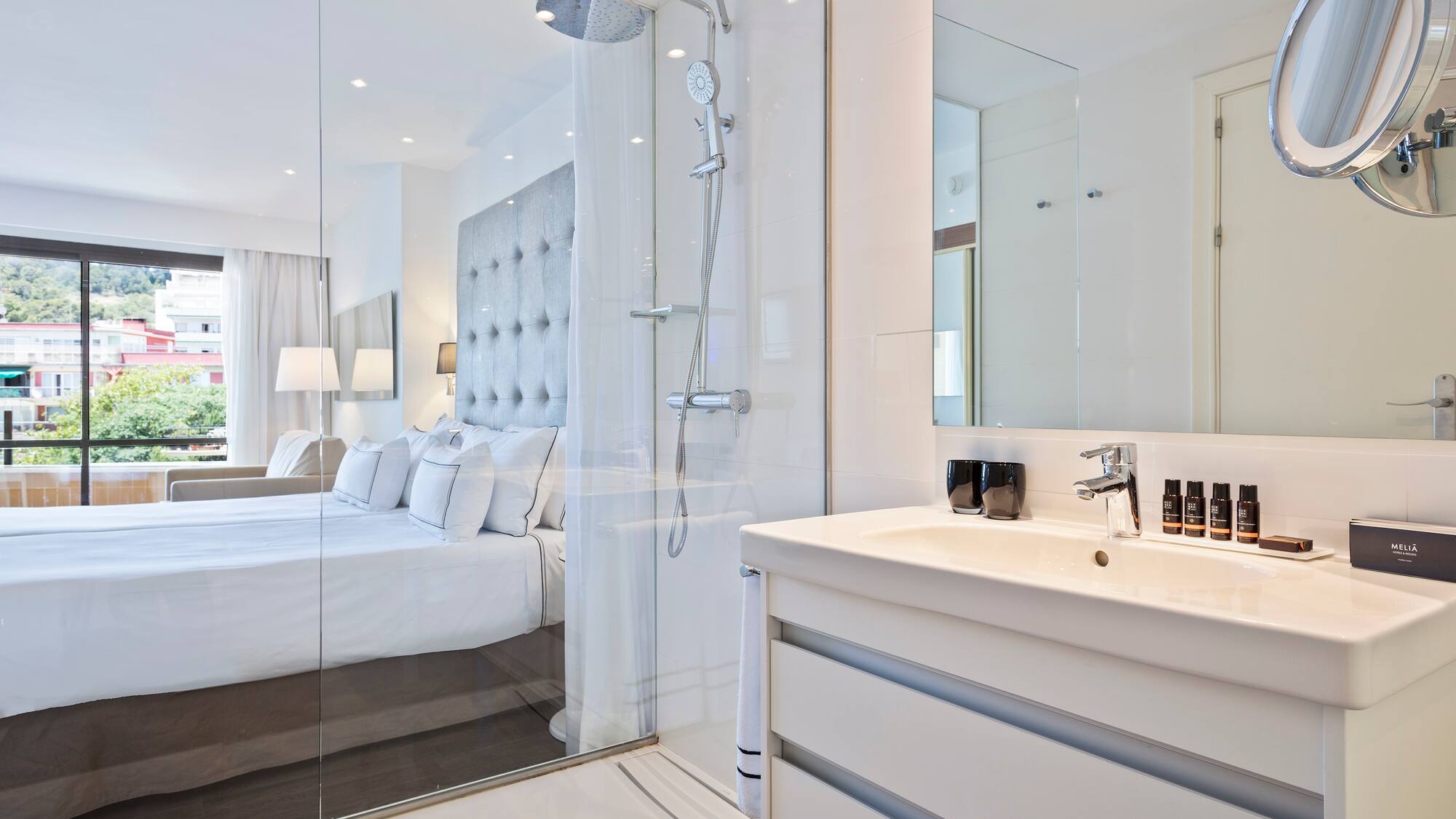 a bathroom with a shower and a bed