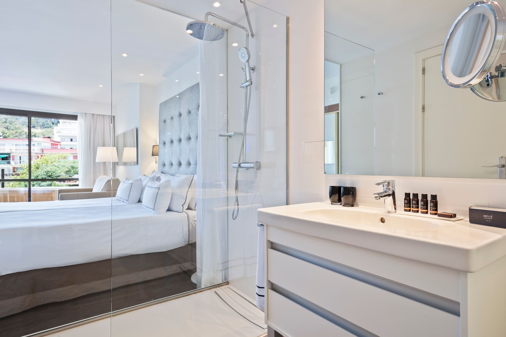 a bathroom with a shower and a bed