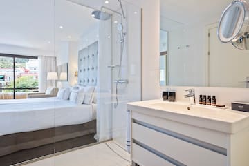 a bathroom with a shower and a bed